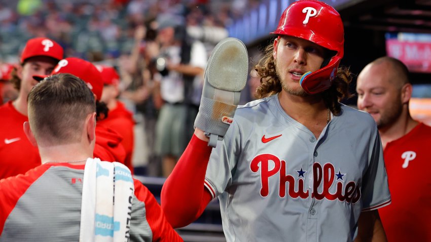 ATLANTA, GA – AUGUST 20:   Alec Bohm #28 of the Philadelphia Phillies celebrates with teammates in the dugout after scoring to tie the game in the fourth inning during the game between the Philadelphia Phillies and the Atlanta Braves at Truist Park on Tuesday, August 20, 2024 in Atlanta, Georgia. (Photo by Todd Kirkland/MLB Photos via Getty Images)