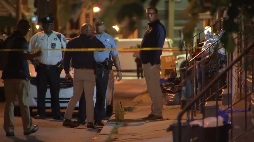 Police investigate after a man was shot while sitting in a car along Peach Street in West Philadelphia late Wednesday.